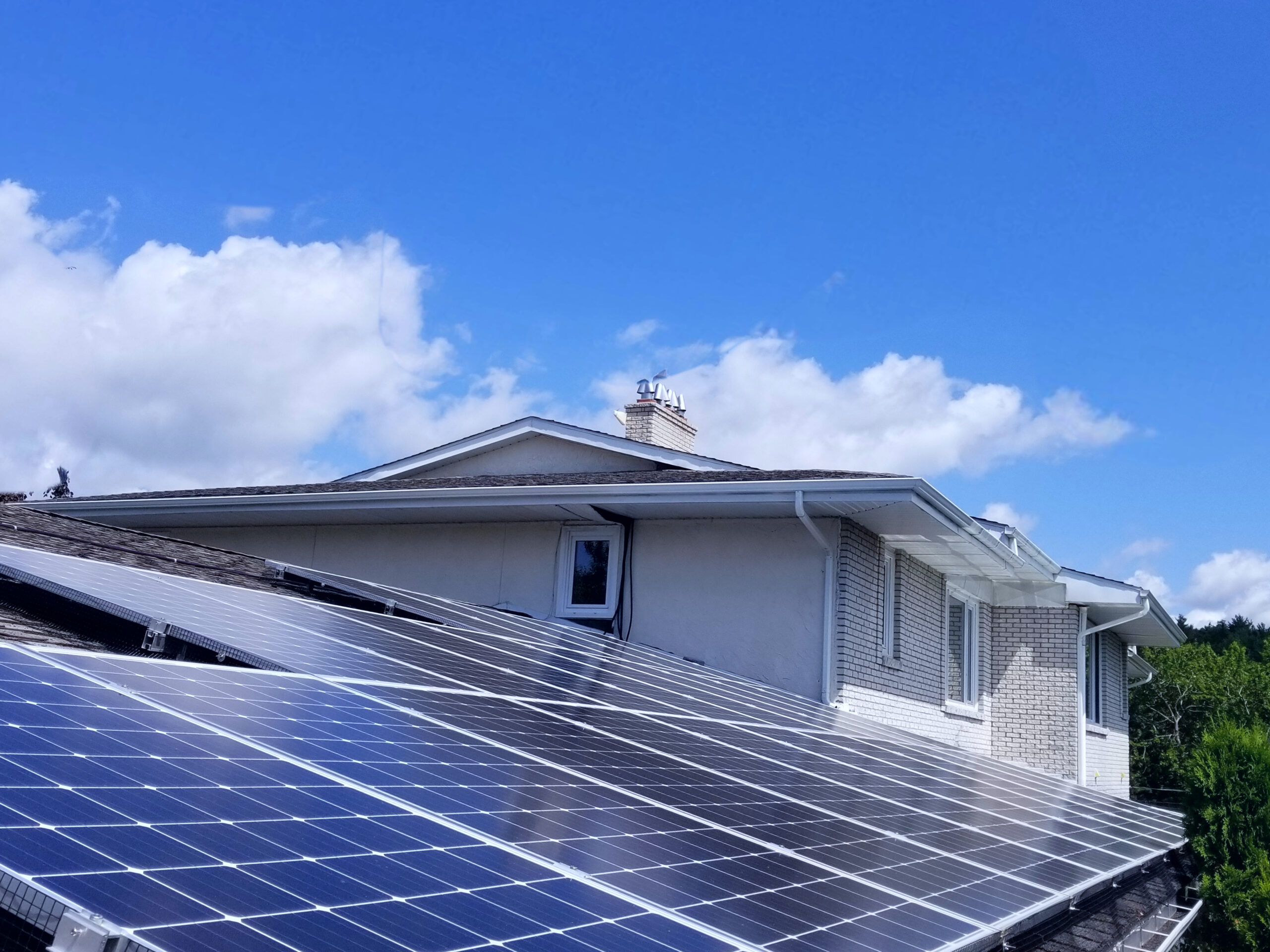 "Solar panels on a home roof reducing energy bills and increasing savings with renewable energy, optimized for Nova Scotia homeowners."