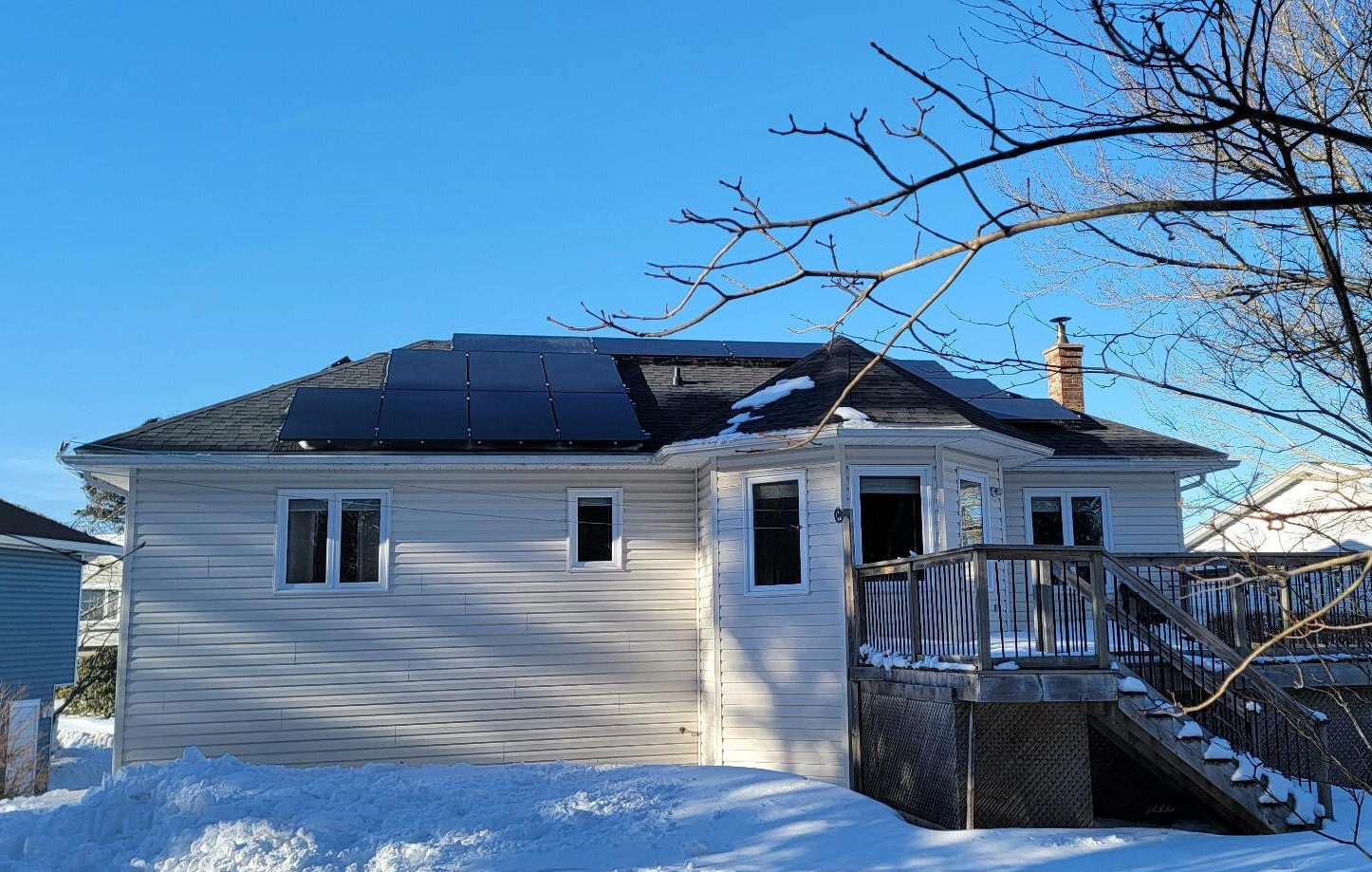 "High-efficiency solar panels installed on a snowy roof in Nova Scotia, capturing maximum sunlight during the winter."